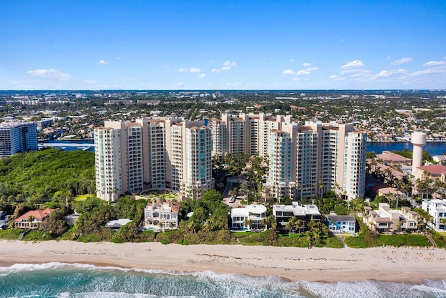 birds eye view of property with a view of the beach, a water view, and a city view