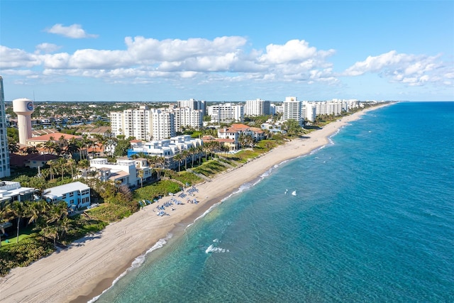 bird's eye view with a water view, a city view, and a view of the beach