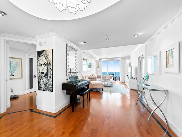 living room with baseboards, hardwood / wood-style floors, and crown molding