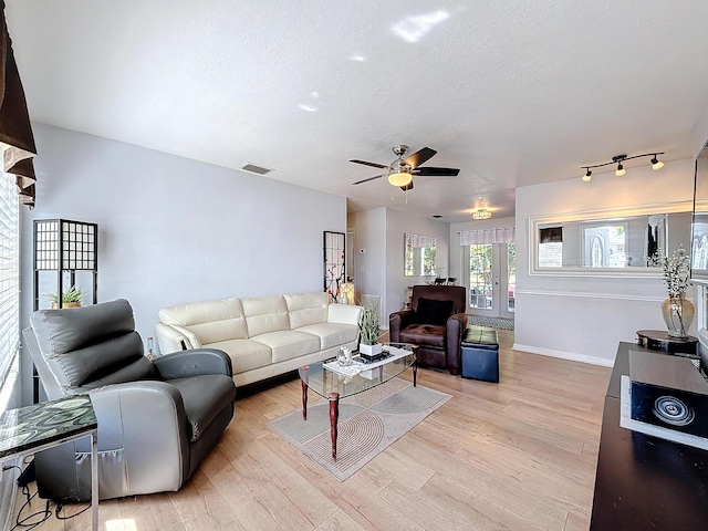 6293 NW 27th St, Margate, FL 33063 - living area with light wood finished floors, visible vents, ceiling fan, a textured ceiling, and baseboards