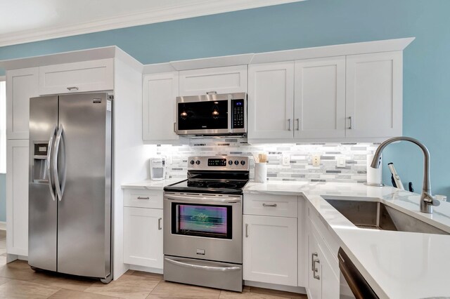 6782 Hillsdale Pt, Boynton Beach, FL 33437 - kitchen with appliances with stainless steel finishes, white cabinets, a sink, and tasteful backsplash