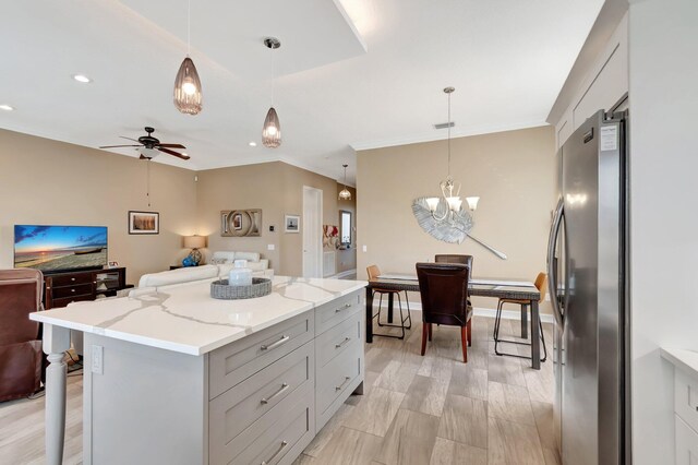6782 Hillsdale Pt, Boynton Beach, FL 33437 - kitchen featuring open floor plan, a breakfast bar area, pendant lighting, and freestanding refrigerator