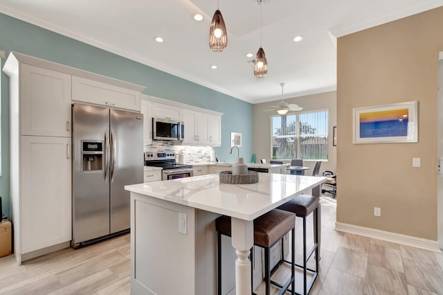 6782 Hillsdale Pt, Boynton Beach, FL 33437 - kitchen featuring stainless steel appliances, white cabinets, hanging light fixtures, a center island, and a kitchen bar