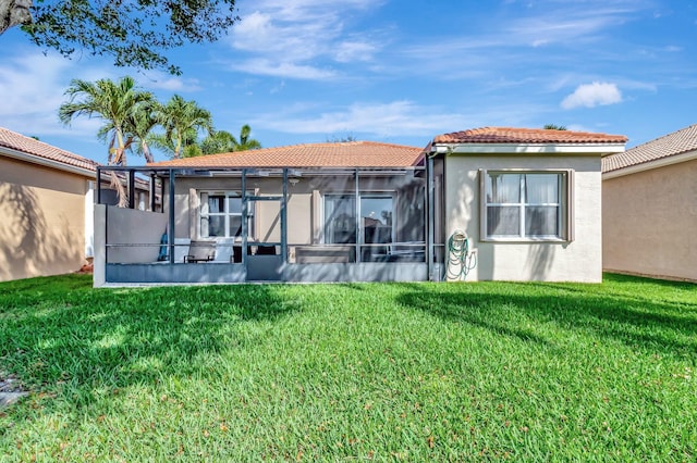 6782 Hillsdale Pt, Boynton Beach, FL 33437 - back of house with glass enclosure, stucco siding, a lawn, and a tiled roof