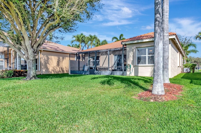 6782 Hillsdale Pt, Boynton Beach, FL 33437 - rear view of property featuring a tile roof, a lawn, and stucco siding
