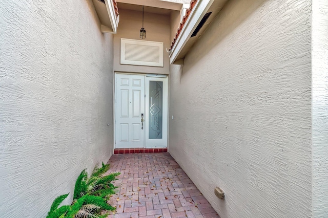 6782 Hillsdale Pt, Boynton Beach, FL 33437 - view of exterior entry with visible vents and stucco siding