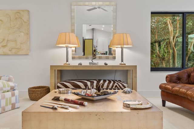 sitting room featuring carpet floors and baseboards