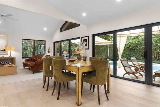 dining room with a wealth of natural light, lofted ceiling with beams, and recessed lighting