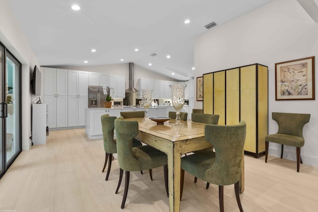 dining room with light wood-type flooring, visible vents, vaulted ceiling, and recessed lighting