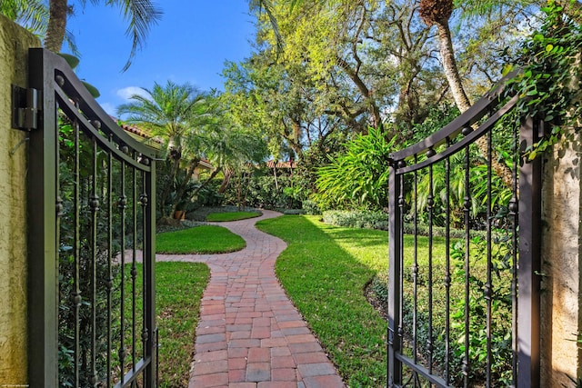 view of gate featuring fence and a yard