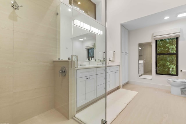 full bath featuring toilet, a towering ceiling, a shower stall, and vanity