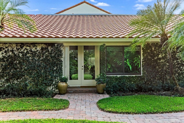 property entrance featuring french doors and a tile roof