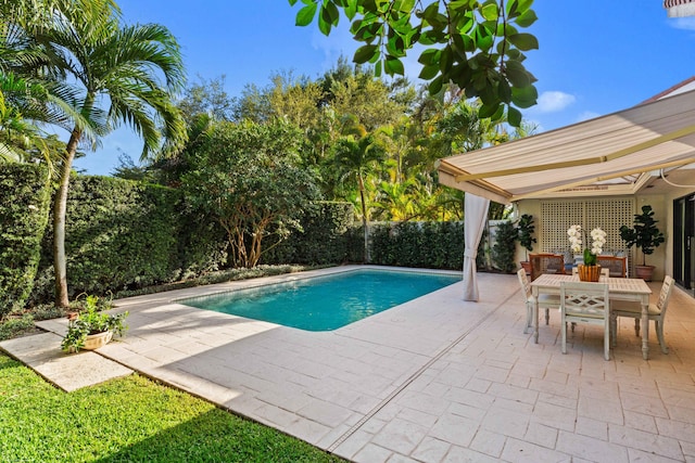 view of pool featuring a patio, outdoor dining area, a fenced backyard, and a fenced in pool