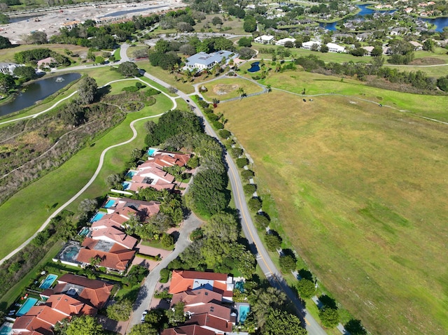 drone / aerial view featuring a water view and a residential view