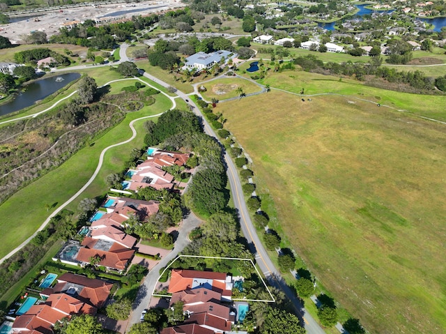 drone / aerial view featuring a water view and a residential view