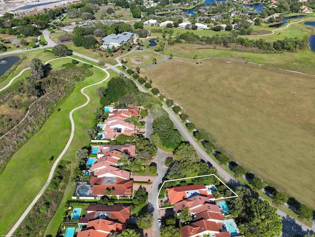 birds eye view of property featuring a water view, a residential view, and golf course view