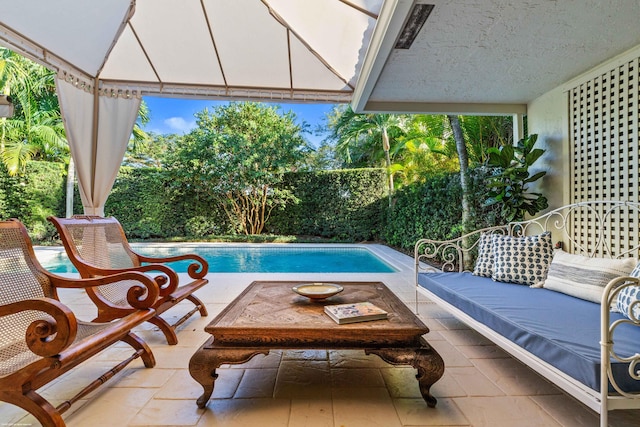 view of pool featuring a fenced in pool, outdoor lounge area, and a patio