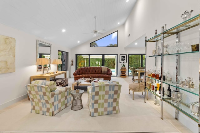 carpeted living area with high vaulted ceiling, recessed lighting, a dry bar, and a ceiling fan