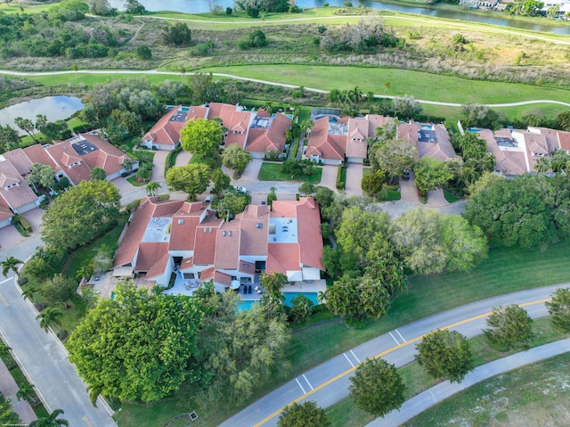 drone / aerial view with a water view, a residential view, and golf course view