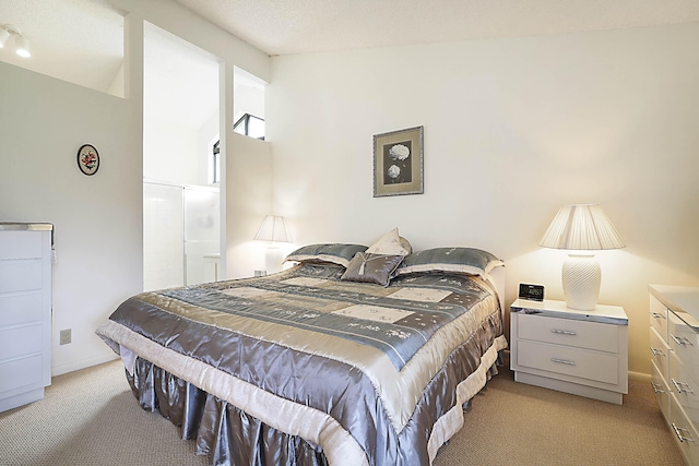 bedroom featuring light colored carpet and baseboards