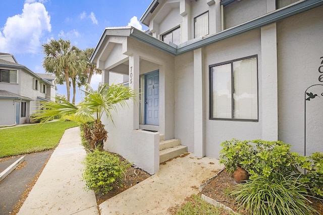 entrance to property with stucco siding