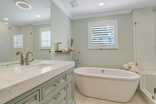 bathroom featuring a soaking tub, visible vents, ornamental molding, and vanity