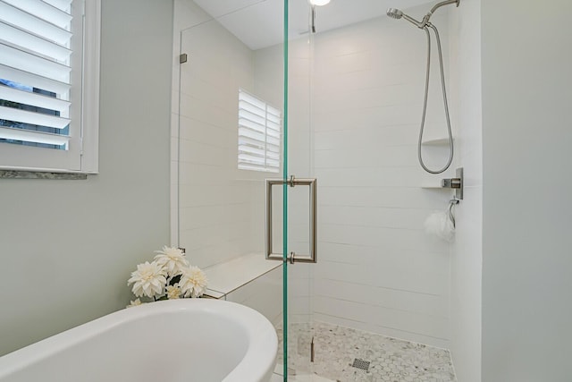 bathroom with a freestanding bath and a stall shower