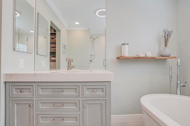 bathroom featuring baseboards, a soaking tub, walk in shower, crown molding, and vanity