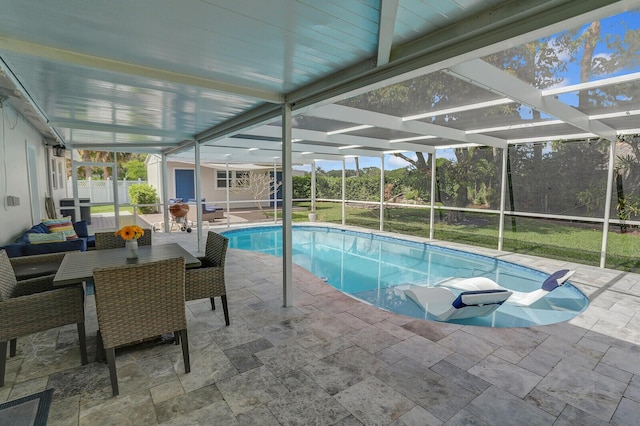 outdoor pool featuring a patio, fence, and glass enclosure