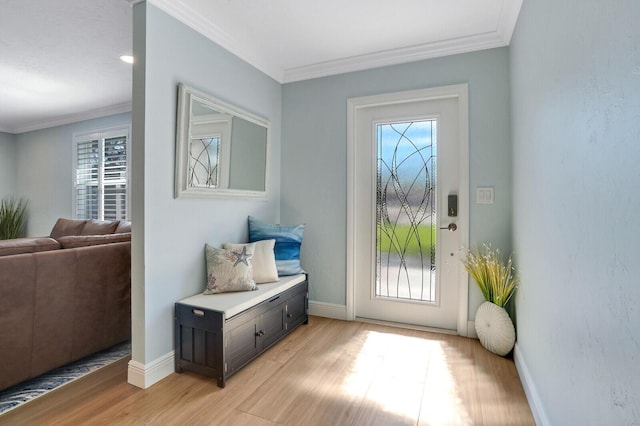 doorway to outside featuring baseboards, light wood-style flooring, and crown molding