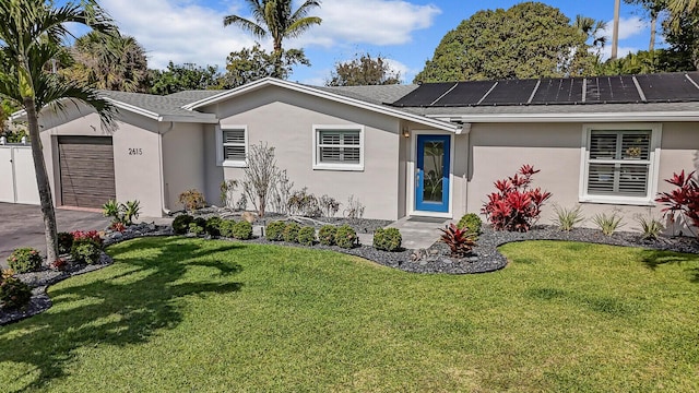 ranch-style home featuring a front lawn, roof mounted solar panels, an attached garage, and stucco siding