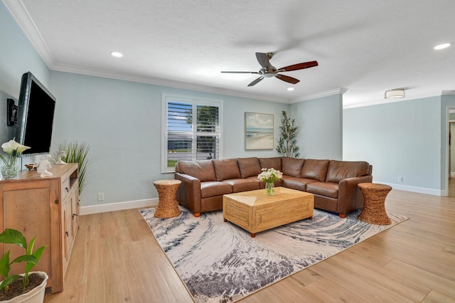 living room with light wood-style flooring, ornamental molding, and baseboards