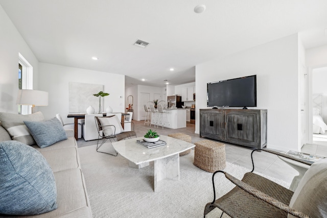 living area with visible vents and recessed lighting