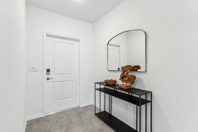 doorway to outside featuring baseboards