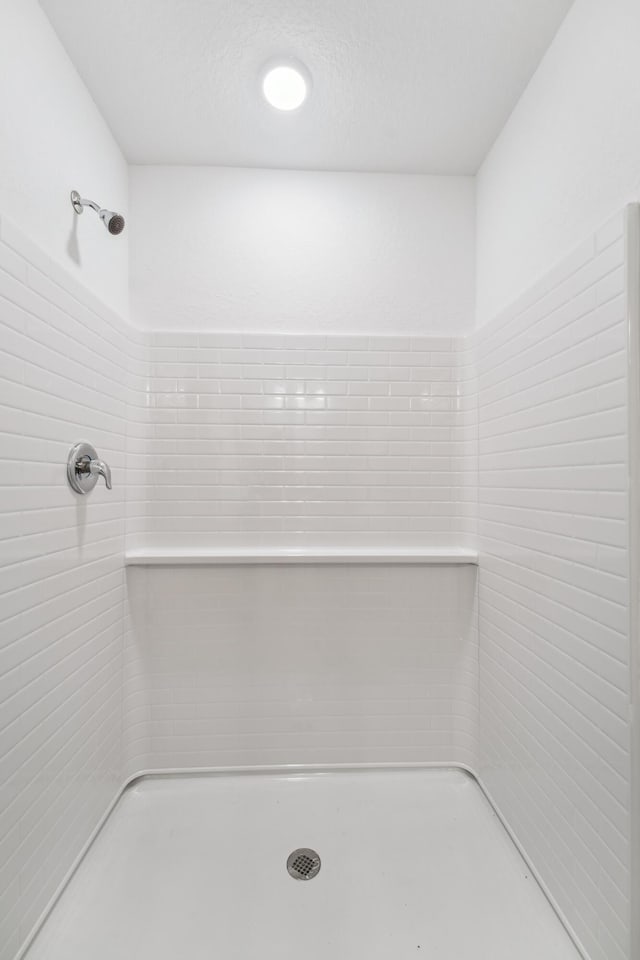 bathroom with tiled shower