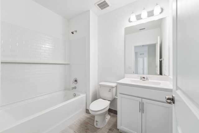 full bathroom with visible vents, toilet, vanity, wood finished floors, and  shower combination