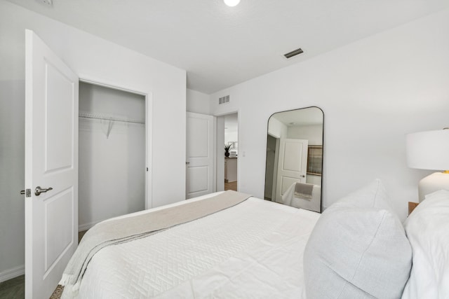 bedroom with a closet and visible vents