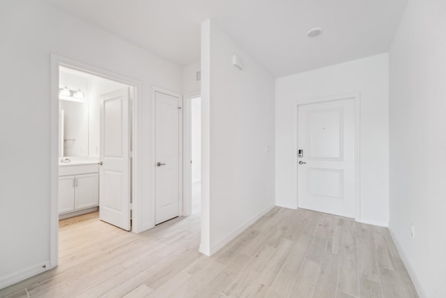 interior space with light wood-style floors and baseboards