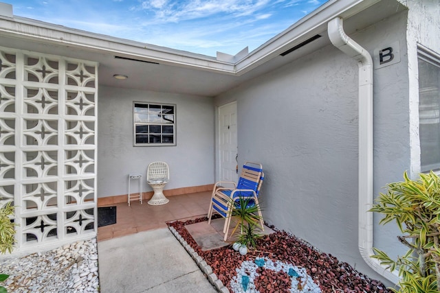 property entrance with stucco siding