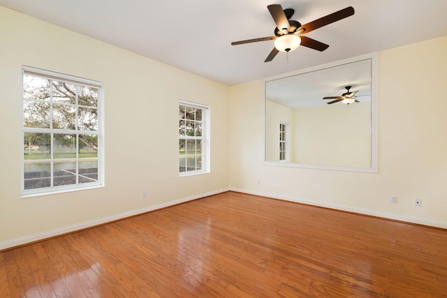 unfurnished room featuring wood finished floors and baseboards