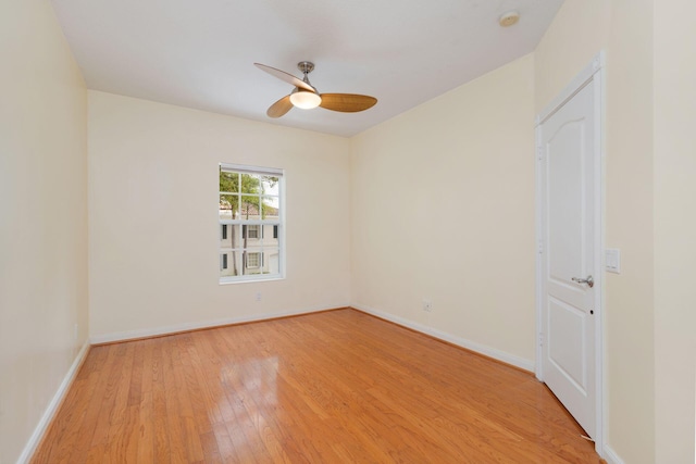 spare room with light wood-style flooring, baseboards, and a ceiling fan