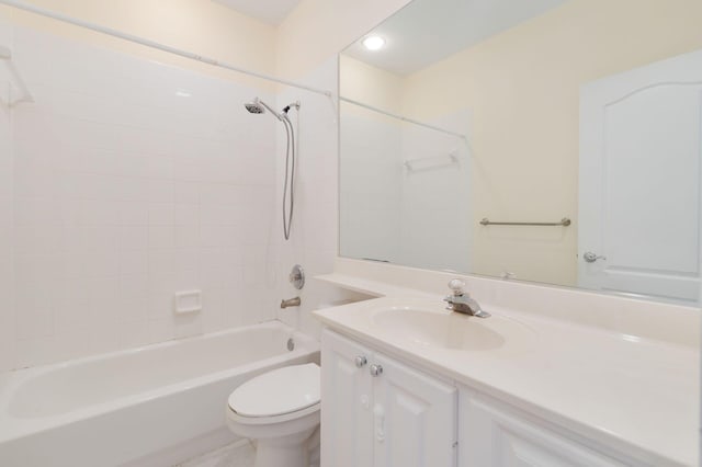 bathroom with bathtub / shower combination, vanity, and toilet