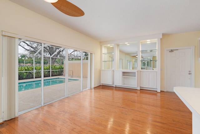 interior space with light wood-style flooring and ceiling fan