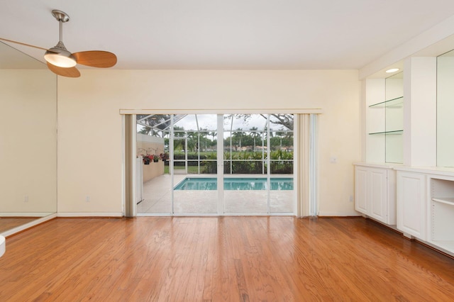 spare room with ceiling fan, light wood finished floors, and plenty of natural light