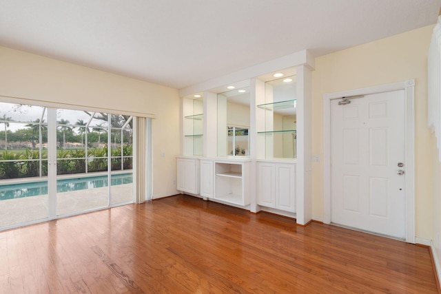 spare room featuring wood finished floors and baseboards