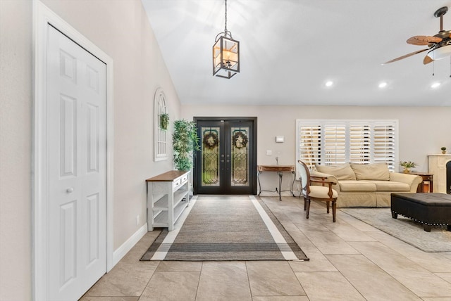 foyer entrance featuring a ceiling fan, recessed lighting, light tile patterned floors, baseboards, and vaulted ceiling