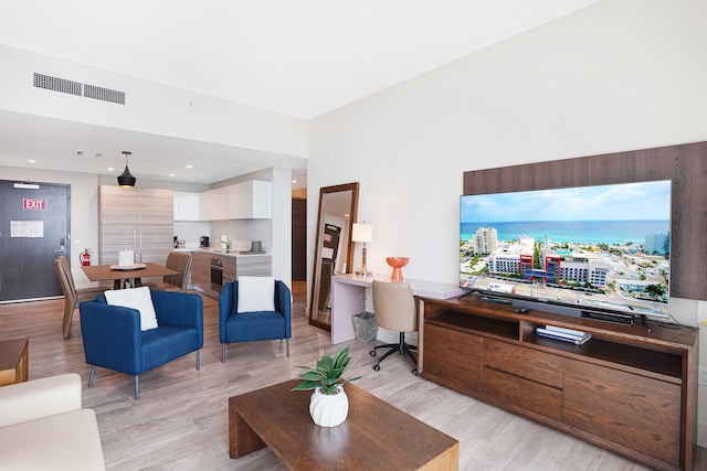 living room featuring light wood finished floors and visible vents