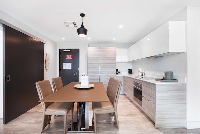 dining space with recessed lighting, visible vents, and light wood-style flooring