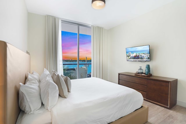 bedroom featuring access to outside and light wood-style flooring