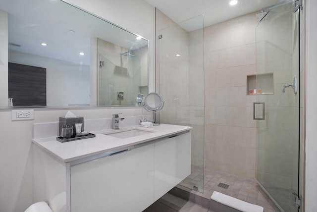 full bathroom with a shower stall, vanity, and recessed lighting